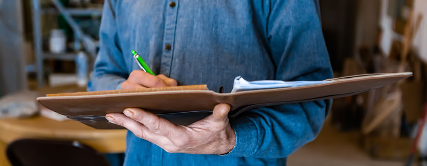 image of a real estate appraiser taking notes during an inspection