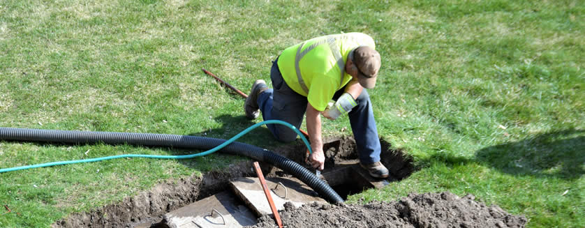 image of a worker draining septic system related to appraisal expert work