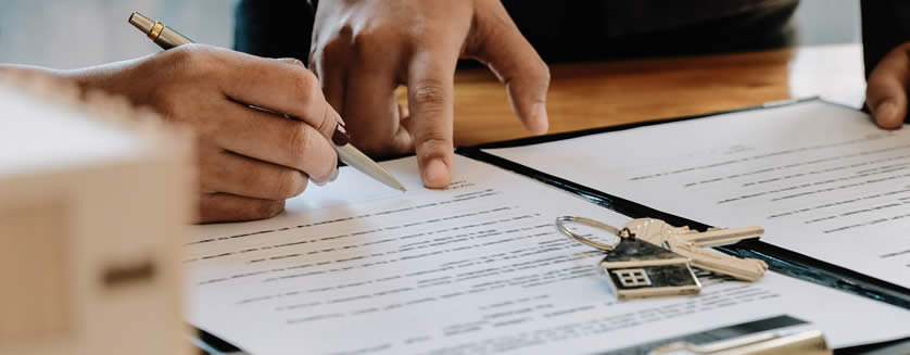 photo concept of a real estate agent pointing where to sign a contract